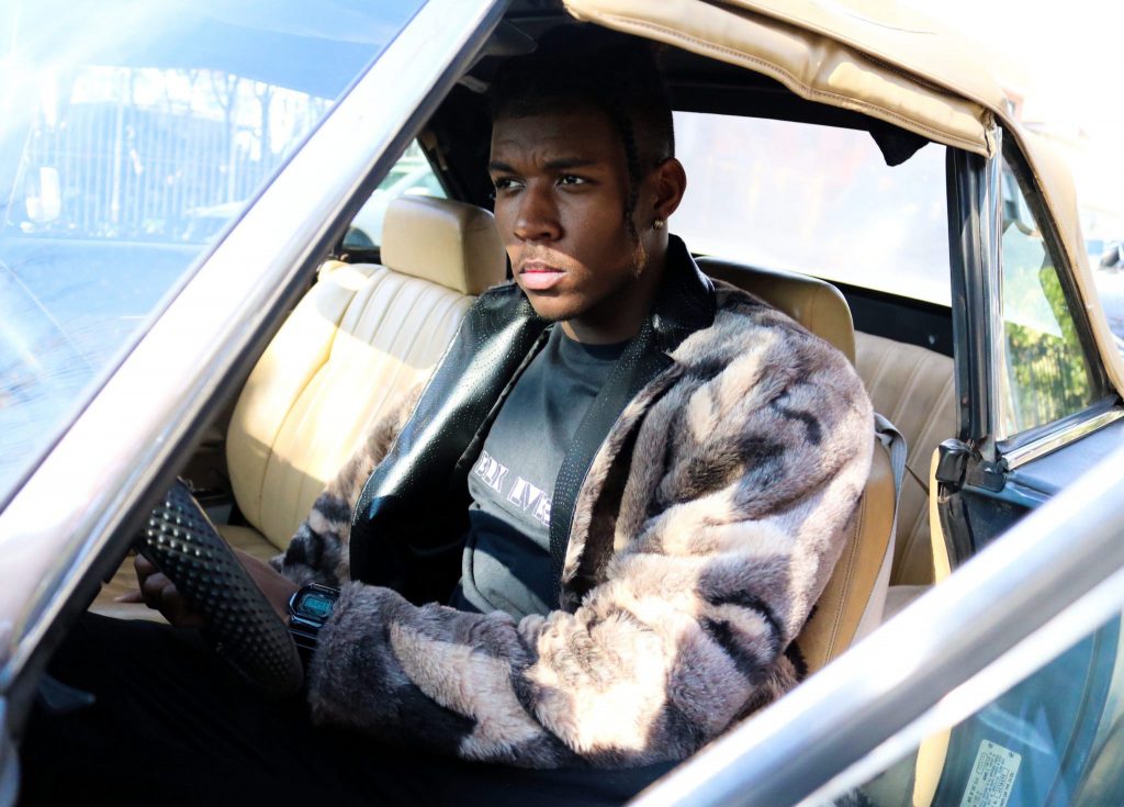teen driver in automobile focused on driving